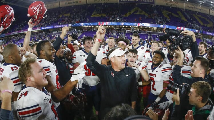 Dec 21, 2019; Orlando, Florida, USA; Liberty Flames head coach Hugh Freeze (middle) celebrates with his team after winning the Cure Bowl  against Georgia the Southern Eagles at Exploria Stadium. Mandatory Credit: Reinhold Matay-USA TODAY Sports