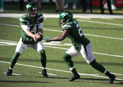 Nov 29, 2020; East Rutherford, New Jersey, USA; New York Jets quarterback Sam Darnold (14) hands the ball off to running back Frank Gore (21) against the Miami Dolphins during the first half at MetLife Stadium. Mandatory Credit: Vincent Carchietta-USA TODAY Sports