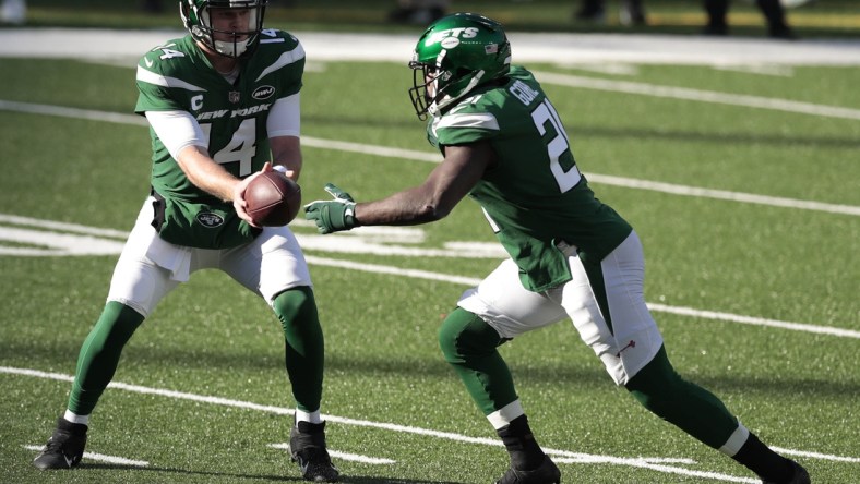 Nov 29, 2020; East Rutherford, New Jersey, USA; New York Jets quarterback Sam Darnold (14) hands the ball off to running back Frank Gore (21) against the Miami Dolphins during the first half at MetLife Stadium. Mandatory Credit: Vincent Carchietta-USA TODAY Sports