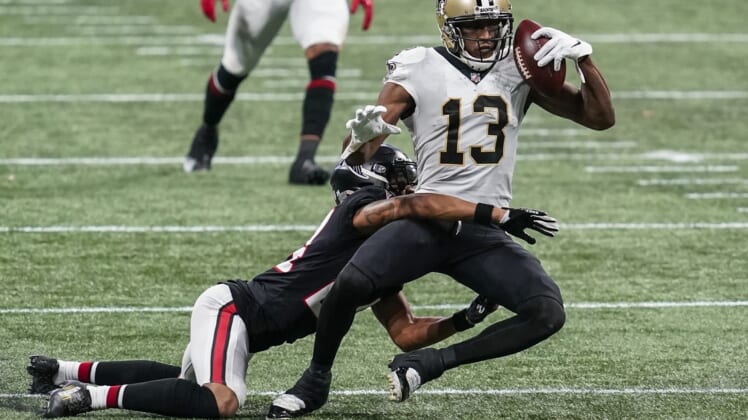 Dec 6, 2020; Atlanta, Georgia, USA; New Orleans Saints wide receiver Michael Thomas (13) holds on to the ball while being tackled by Atlanta Falcons cornerback A.J. Terrell (24)  during the second half at Mercedes-Benz Stadium. Mandatory Credit: Dale Zanine-USA TODAY Sports