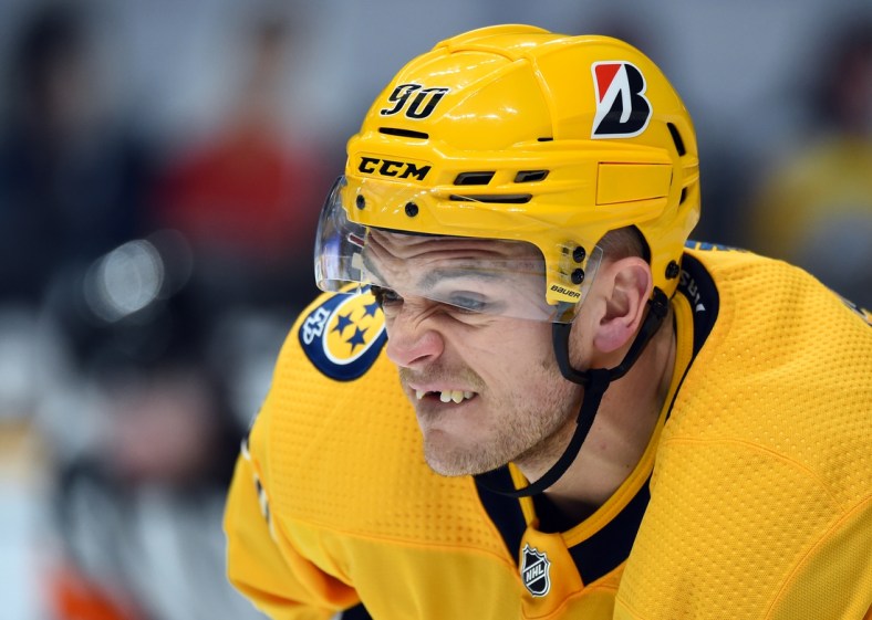 Feb 13, 2021; Nashville, Tennessee, USA; Nashville Predators defenseman Mark Borowiecki (90) lines up for a face off against the Detroit Red Wings during the second period at Bridgestone Arena. Mandatory Credit: Christopher Hanewinckel-USA TODAY Sports