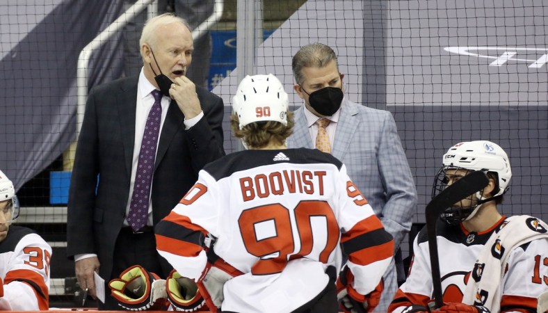 Apr 20, 2021; Pittsburgh, Pennsylvania, USA;  New Jersey Devils head coach Lindy Ruff (left) reacts on the bench against the Pittsburgh Penguins during the second period at PPG Paints Arena. Mandatory Credit: Charles LeClaire-USA TODAY Sports