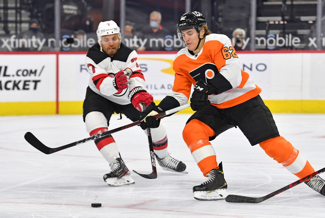 May 10, 2021; Philadelphia, Pennsylvania, USA; Philadelphia Flyers right wing Nicolas Aube-Kubel (62) moves around New Jersey Devils defenseman Matt Tennyson (7) during the first period at Wells Fargo Center. Mandatory Credit: Eric Hartline-USA TODAY Sports