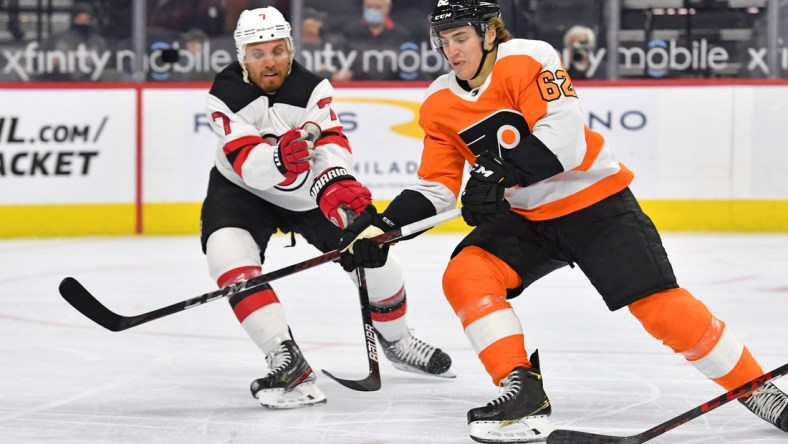 May 10, 2021; Philadelphia, Pennsylvania, USA; Philadelphia Flyers right wing Nicolas Aube-Kubel (62) moves around New Jersey Devils defenseman Matt Tennyson (7) during the first period at Wells Fargo Center. Mandatory Credit: Eric Hartline-USA TODAY Sports