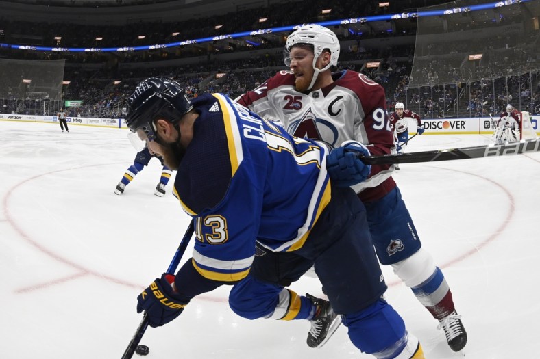 May 21, 2021; St. Louis, Missouri, USA; Colorado Avalanche left wing Gabriel Landeskog (92) checks St. Louis Blues left wing Kyle Clifford (13)in game three of the first round of the 2021 Stanley Cup Playoffs at Enterprise Center. Mandatory Credit: Jeff Le-USA TODAY Sports