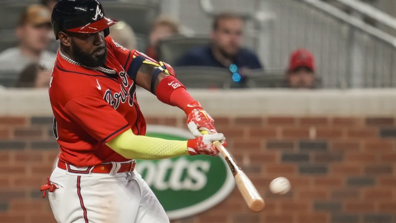 May 21, 2021; Cumberland, Georgia, USA; Atlanta Braves left fielder Marcell Ozuna (20) hits a home run against the Pittsburgh Pirates during the sixth inning at Truist Park. Mandatory Credit: Dale Zanine-USA TODAY Sports