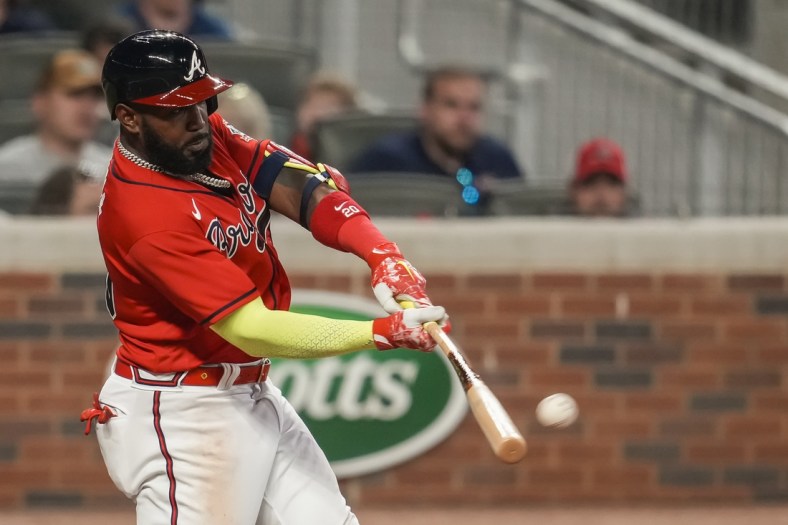 May 21, 2021; Cumberland, Georgia, USA; Atlanta Braves left fielder Marcell Ozuna (20) hits a home run against the Pittsburgh Pirates during the sixth inning at Truist Park. Mandatory Credit: Dale Zanine-USA TODAY Sports