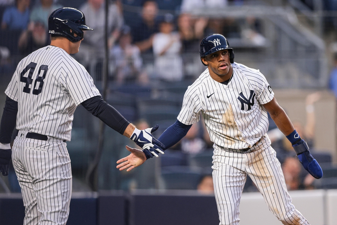 Aug 3, 2021; Bronx, New York, USA; New York Yankees left fielder Greg Allen (22) slaps hands with first baseman Anthony Rizzo (48) after scoring a run during the third inning against the Baltimore Orioles at Yankee Stadium. Mandatory Credit: Vincent Carchietta-USA TODAY Sports