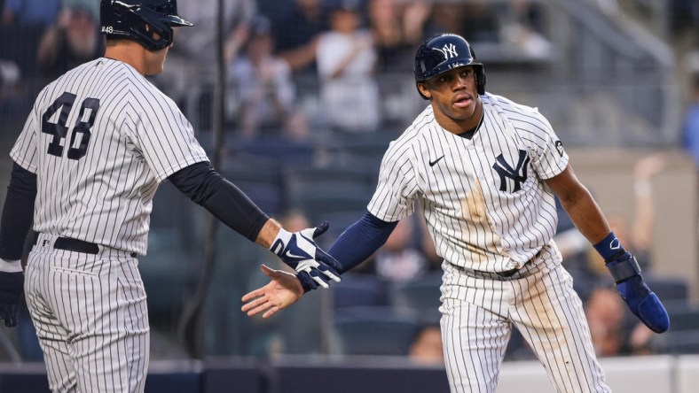 Aug 3, 2021; Bronx, New York, USA; New York Yankees left fielder Greg Allen (22) slaps hands with first baseman Anthony Rizzo (48) after scoring a run during the third inning against the Baltimore Orioles at Yankee Stadium. Mandatory Credit: Vincent Carchietta-USA TODAY Sports