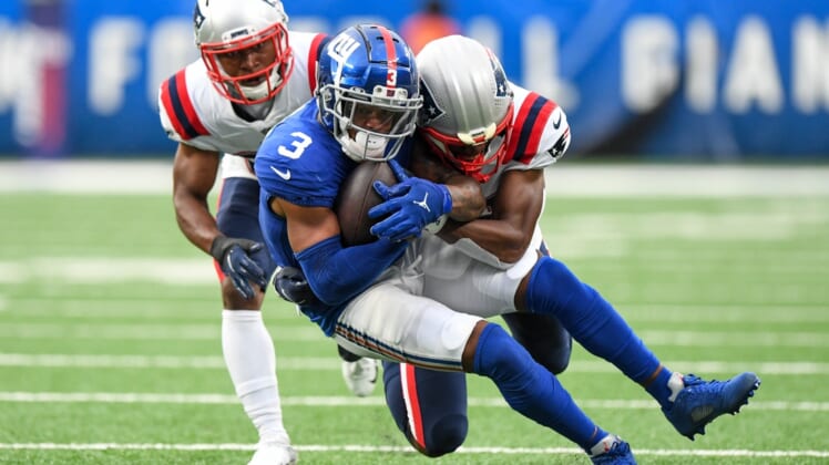 Aug 29, 2021; East Rutherford, New Jersey, USA;  New England Patriots cornerback Mike Jackson (35) makes a tackles on New York Giants wide receiver Sterling Shepard (3) during the second quarte at MetLife Stadium. Mandatory Credit: Dennis Schneidler-USA TODAY Sports