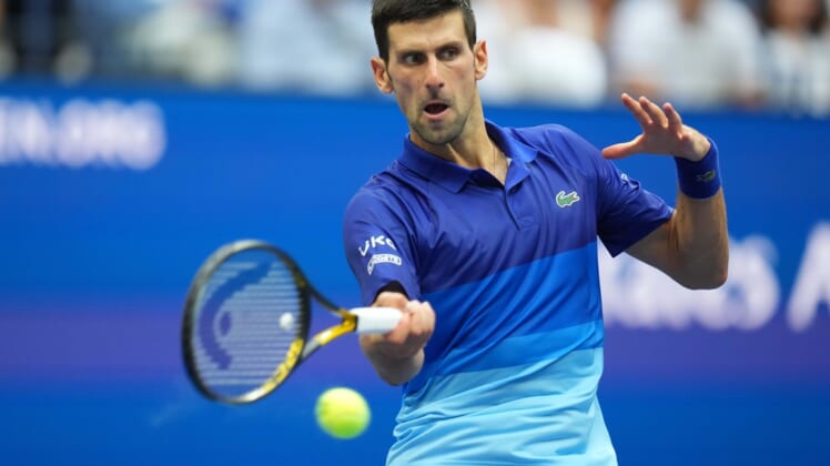 Sep 12, 2021; Flushing, NY, USA; Novak Djokovic of Serbia hits a forehand against Daniil Medvedev of Russia (not pictured) in the men's singles final on day fourteen of the 2021 U.S. Open tennis tournament at USTA Billie Jean King National Tennis Center. Mandatory Credit: Danielle Parhizkaran-USA TODAY Sports