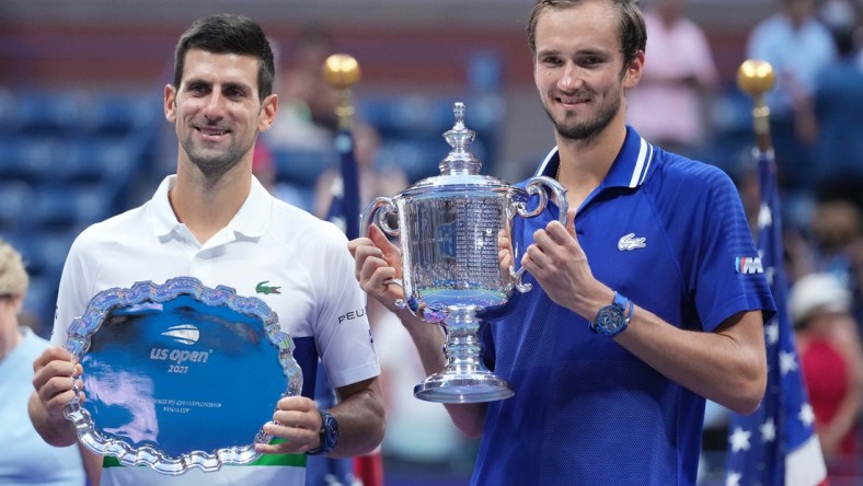 Sep 12, 2021; Flushing, NY, USA; (L-R) Novak Djokovic of Serbia and Daniil Medvedev of Russia celebrate with the finalist and championship trophies, respectively, after their match in the men's singles final on day fourteen of the 2021 U.S. Open tennis tournament at USTA Billie Jean King National Tennis Center. Mandatory Credit: Danielle Parhizkaran-USA TODAY Sports