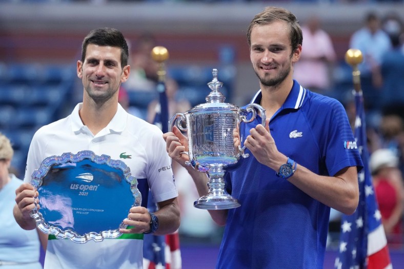 Sep 12, 2021; Flushing, NY, USA; (L-R) Novak Djokovic of Serbia and Daniil Medvedev of Russia celebrate with the finalist and championship trophies, respectively, after their match in the men's singles final on day fourteen of the 2021 U.S. Open tennis tournament at USTA Billie Jean King National Tennis Center. Mandatory Credit: Danielle Parhizkaran-USA TODAY Sports