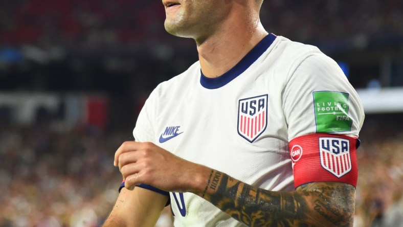 Sep 5, 2021; Nashville, Tennessee, USA; United States star Christian Pulisic (10) on a corner kick against Canada during a CONCACAF FIFA World Cup Qualifier soccer match at Nissan Stadium. Mandatory Credit: Christopher Hanewinckel-USA TODAY Sports