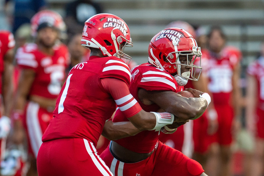 Louisiana Ragin' Cajuns football quarterback Levi Lewis (No. 1) hands the ball to Montrell Johnson Jr. (No. 4) during pre-game warm up as the Cajuns prepare to take on Ohio on Thursday, Sept. 16, 2021.

Cajuns Vs Ohio Football Pregame 5734