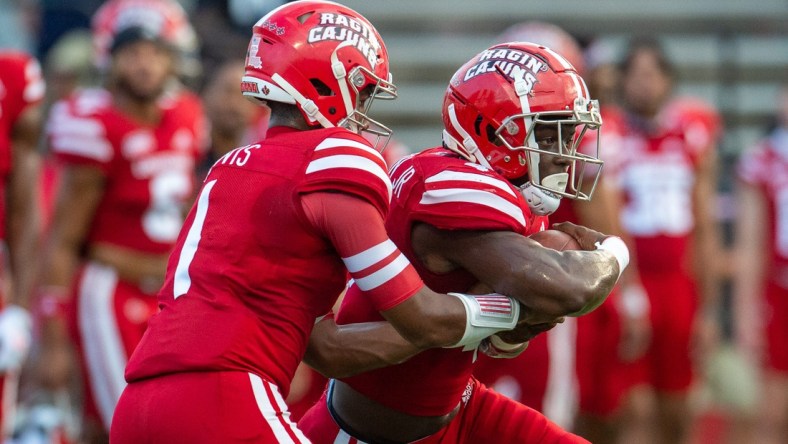 Louisiana Ragin' Cajuns football quarterback Levi Lewis (No. 1) hands the ball to Montrell Johnson Jr. (No. 4) during pre-game warm up as the Cajuns prepare to take on Ohio on Thursday, Sept. 16, 2021.

Cajuns Vs Ohio Football Pregame 5734