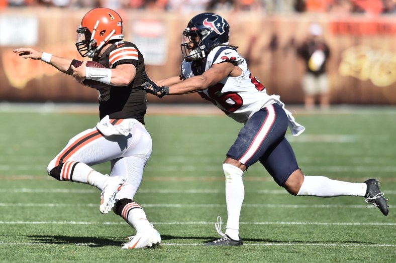 Sep 19, 2021; Cleveland, Ohio, USA; Houston Texans cornerback Vernon Hargreaves III (26) chases Cleveland Browns quarterback Baker Mayfield (6) during the second half at FirstEnergy Stadium. Mandatory Credit: Ken Blaze-USA TODAY Sports
