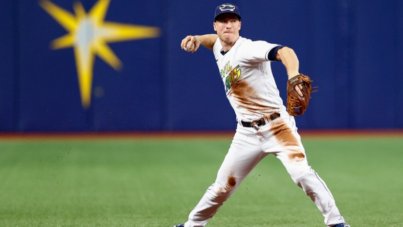 Sep 25, 2021; St. Petersburg, Florida, USA;  Tampa Bay Rays shortstop Joey Wendle (18) throws to first for an out in the first inning against the Miami Marlins at Tropicana Field. Mandatory Credit: Nathan Ray Seebeck-USA TODAY Sports