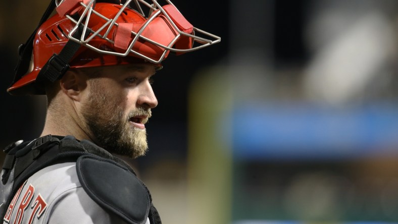 Oct 1, 2021; Pittsburgh, Pennsylvania, USA; Cincinnati Reds catcher Tucker Barnhart (16) looks on against the Pittsburgh Pirates during the fifth inning at PNC Park. Mandatory Credit: Charles LeClaire-USA TODAY Sports