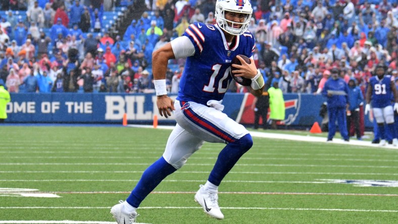 Oct 3, 2021; Orchard Park, New York, USA; Buffalo Bills quarterback Mitchell Trubisky (10) runs for a touchdown in the fourth quarter against the Houston Texans at Highmark Stadium. Mandatory Credit: Mark Konezny-USA TODAY Sports