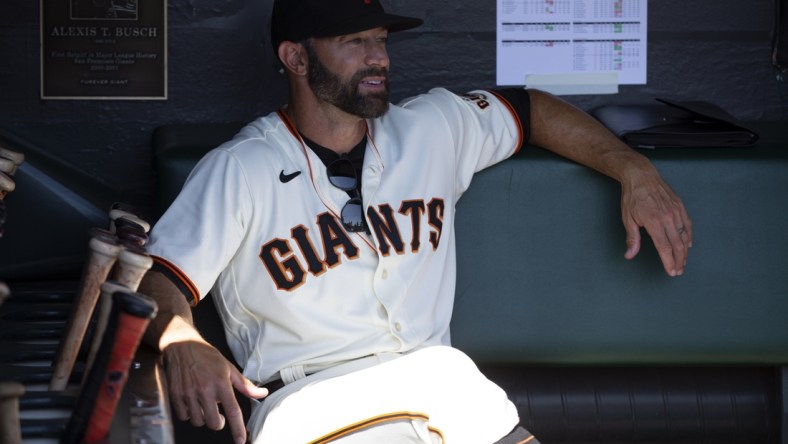 Oct 3, 2021; San Francisco, California, USA; San Francisco Giants manager Gabe Kapler (19) sits in the dugout before a game against the San Diego Padres at Oracle Park. Mandatory Credit: D. Ross Cameron-USA TODAY Sports