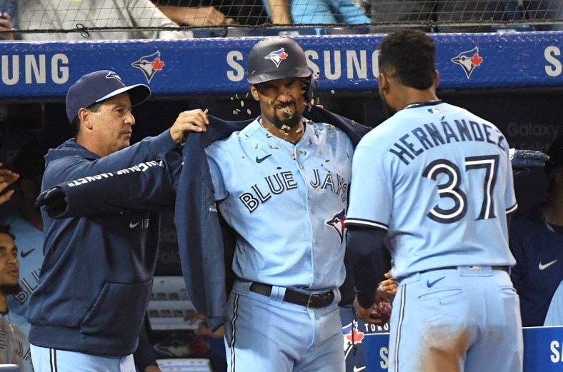 Oct 3, 2021; Toronto, Ontario, CAN;  Toronto Blue Jays second baseman Marcus Semien (10) celebrates with manager Charlie Montoyo (left) and left fielder Teoscar Hernandez (37) after hitting a solo home run against the Baltimore Orioles in the fifth inning at Rogers Centre. Mandatory Credit: Dan Hamilton-USA TODAY Sports
