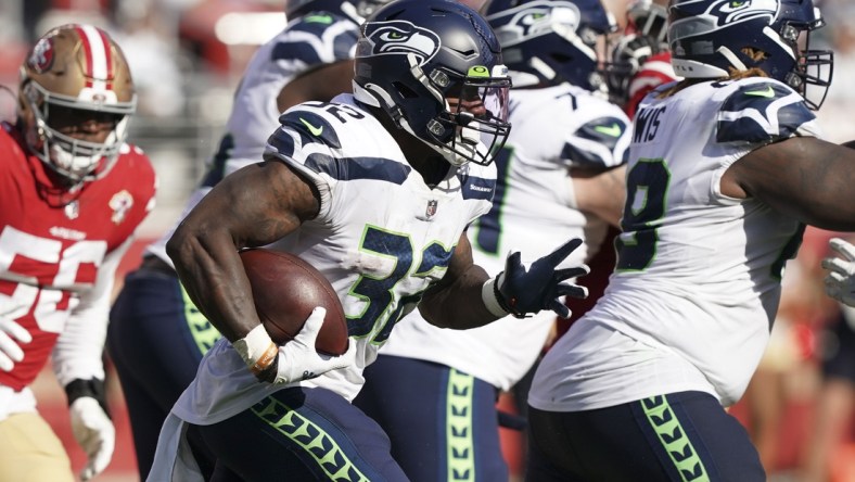 Oct 3, 2021; Santa Clara, California, USA; Seattle Seahawks running back Chris Carson (32) rushes during the fourth quarter against the San Francisco 49ers at Levi's Stadium. Mandatory Credit: Darren Yamashita-USA TODAY Sports