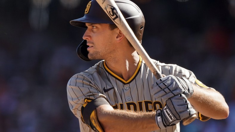 Oct 2, 2021; San Francisco, California, USA; San Diego Padres pinch hitter Adam Frazier (12) bats during the sixth inning against the San Francisco Giants at Oracle Park. Mandatory Credit: Darren Yamashita-USA TODAY Sports