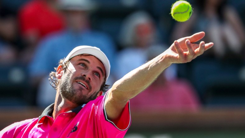 Tommy Paul of the United States serves to Cameron Norrie of Great Britain during their round four match of the BNP Paribas Open, Wednesday, Oct. 13, 2021, in Indian Wells, Calif.