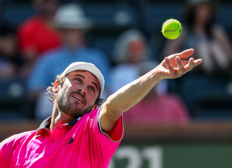 Tommy Paul of the United States serves to Cameron Norrie of Great Britain during their round four match of the BNP Paribas Open, Wednesday, Oct. 13, 2021, in Indian Wells, Calif.