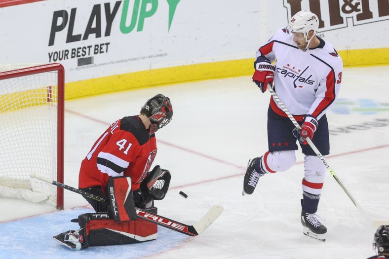 Oct 21, 2021; Newark, New Jersey, USA; New Jersey Devils goaltender Scott Wedgewood (41) makes a save on Washington Capitals right wing Anthony Mantha (39) during the third period at Prudential Center. Mandatory Credit: Ed Mulholland-USA TODAY Sports