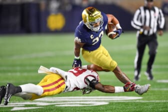 Oct 23, 2021; South Bend, Indiana, USA; Notre Dame Fighting Irish running back Kyren Williams (23) runs the ball as USC Trojans safety Xavion Alford (29) defends in the third quarter at Notre Dame Stadium. Mandatory Credit: Matt Cashore-USA TODAY Sports