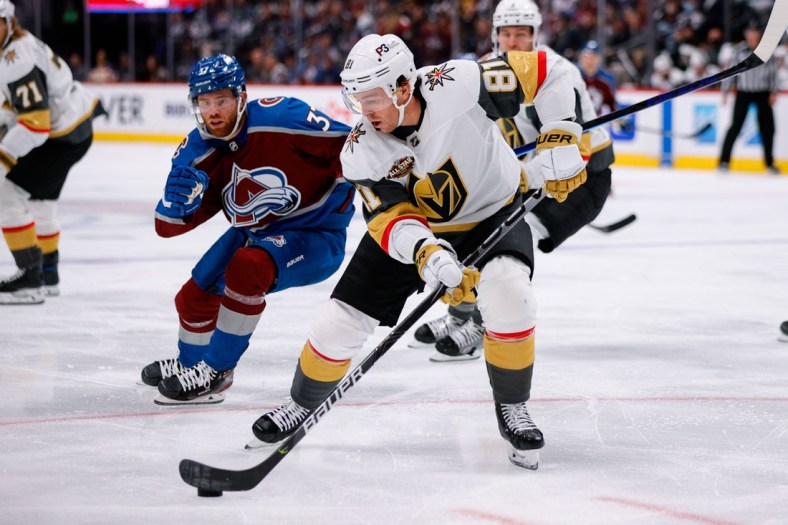 Oct 26, 2021; Denver, Colorado, USA; Vegas Golden Knights center Jonathan Marchessault (81) controls the puck ahead of Colorado Avalanche left wing J.T. Compher (37) in the second period at Ball Arena. Mandatory Credit: Isaiah J. Downing-USA TODAY Sports