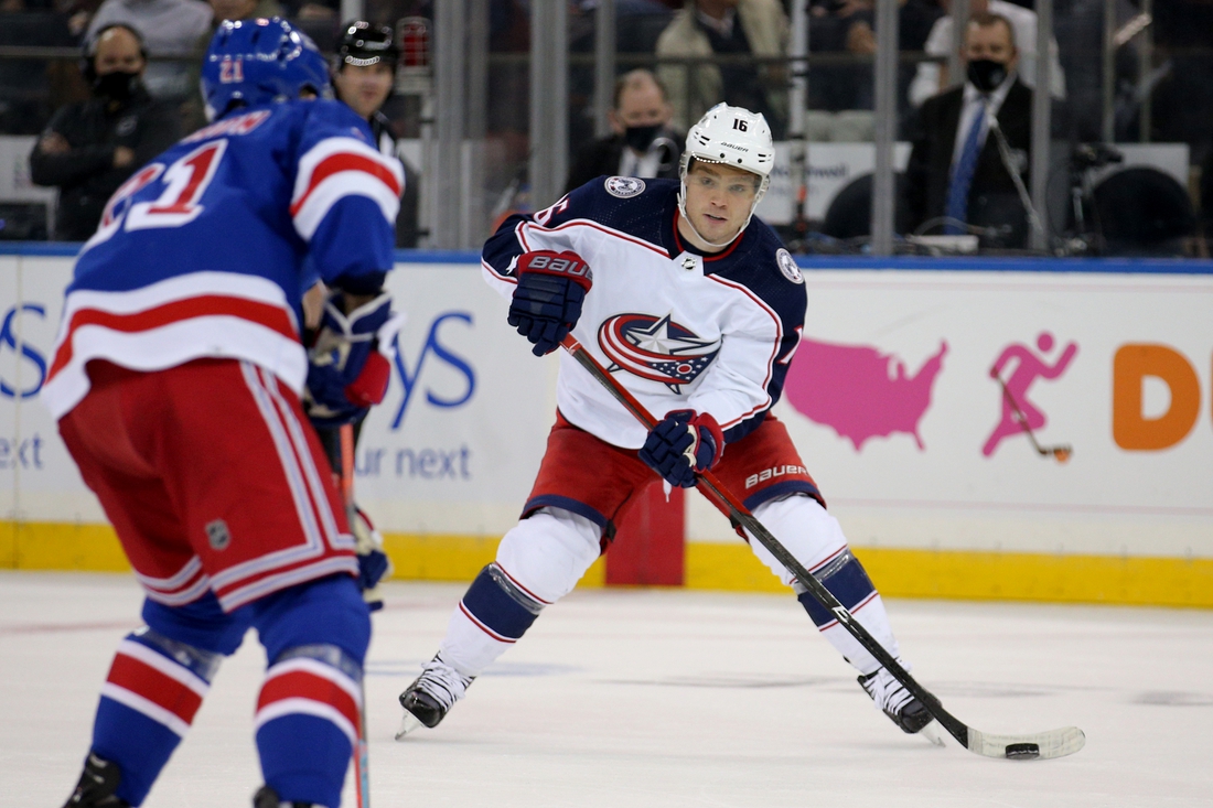 Oct 29, 2021; New York, New York, USA; Columbus Blue Jackets center Max Domi (16) plays the puck against New York Rangers right wing Barclay Goodrow (21) during the second period at Madison Square Garden. Mandatory Credit: Brad Penner-USA TODAY Sports