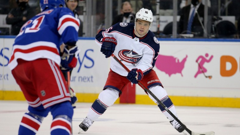 Oct 29, 2021; New York, New York, USA; Columbus Blue Jackets center Max Domi (16) plays the puck against New York Rangers right wing Barclay Goodrow (21) during the second period at Madison Square Garden. Mandatory Credit: Brad Penner-USA TODAY Sports