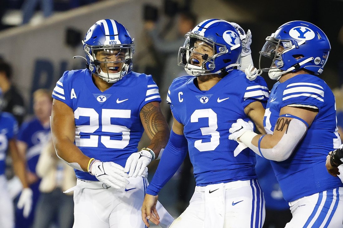 Oct 30, 2021; Provo, Utah, USA; Brigham Young Cougars running back Tyler Allgeier (25) congratulates Brigham Young Cougars quarterback Jaren Hall (3) for his first quarter touchdown against the Virginia Cavaliers at LaVell Edwards Stadium. Mandatory Credit: Jeffrey Swinger-USA TODAY Sports