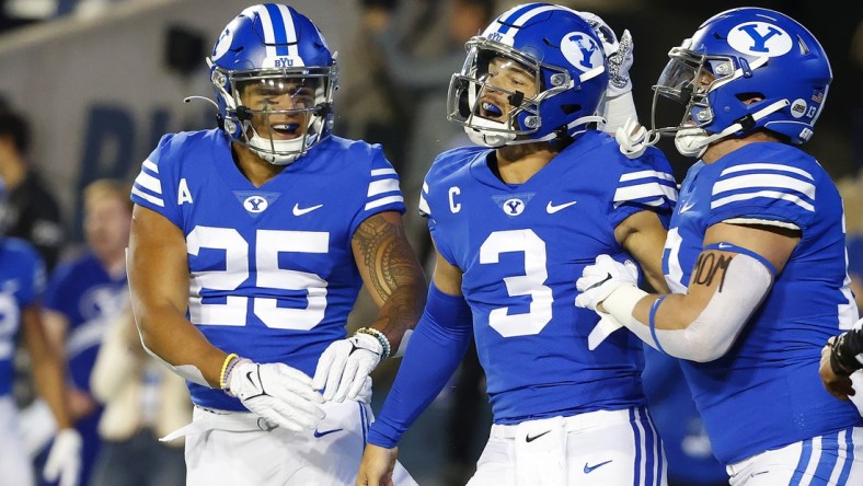 Oct 30, 2021; Provo, Utah, USA; Brigham Young Cougars running back Tyler Allgeier (25) congratulates Brigham Young Cougars quarterback Jaren Hall (3) for his first quarter touchdown against the Virginia Cavaliers at LaVell Edwards Stadium. Mandatory Credit: Jeffrey Swinger-USA TODAY Sports