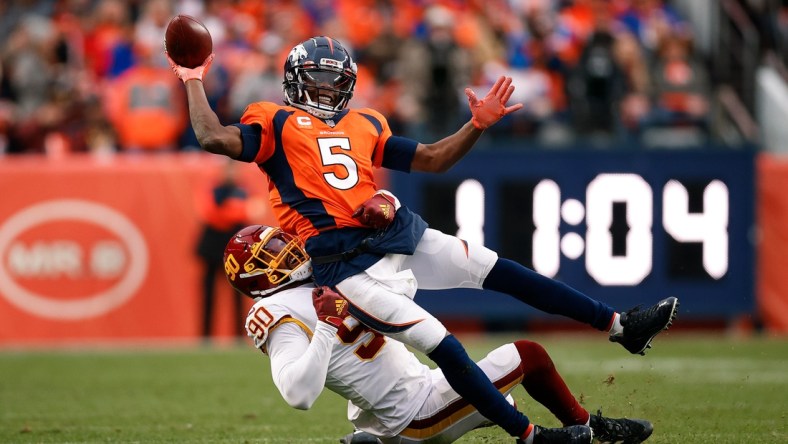 Oct 31, 2021; Denver, Colorado, USA; Denver Broncos quarterback Teddy Bridgewater (5) attempts to pass the ball as he is tackled by Washington Football Team defensive end Montez Sweat (90) in the fourth quarter at Empower Field at Mile High. Mandatory Credit: Isaiah J. Downing-USA TODAY Sports
