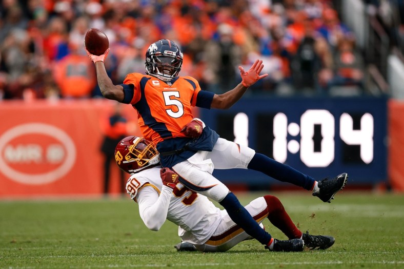 Oct 31, 2021; Denver, Colorado, USA; Denver Broncos quarterback Teddy Bridgewater (5) attempts to pass the ball as he is tackled by Washington Football Team defensive end Montez Sweat (90) in the fourth quarter at Empower Field at Mile High. Mandatory Credit: Isaiah J. Downing-USA TODAY Sports