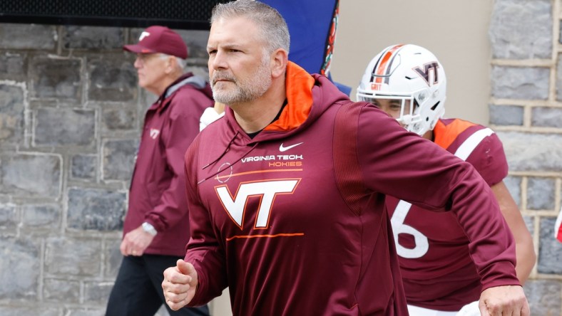 Oct 16, 2021; Blacksburg, Virginia, USA;  Virginia Tech Hokies head coach Justin Fuente leads his team onto the field before the game against the Pittsburgh Panthers at Lane Stadium. Mandatory Credit: Reinhold Matay-USA TODAY Sports