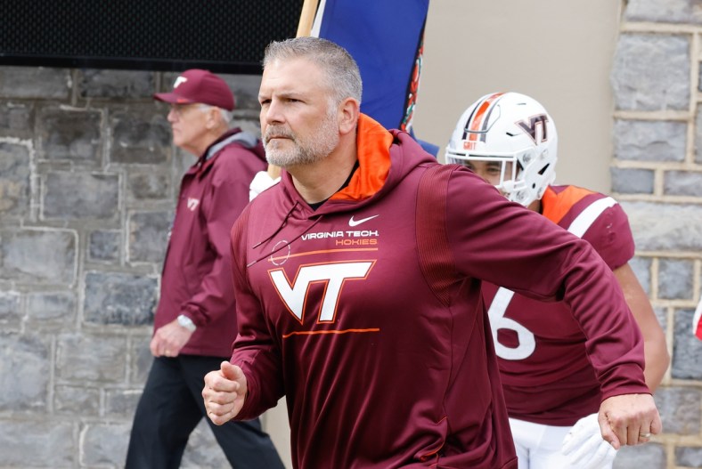 Oct 16, 2021; Blacksburg, Virginia, USA;  Virginia Tech Hokies head coach Justin Fuente leads his team onto the field before the game against the Pittsburgh Panthers at Lane Stadium. Mandatory Credit: Reinhold Matay-USA TODAY Sports
