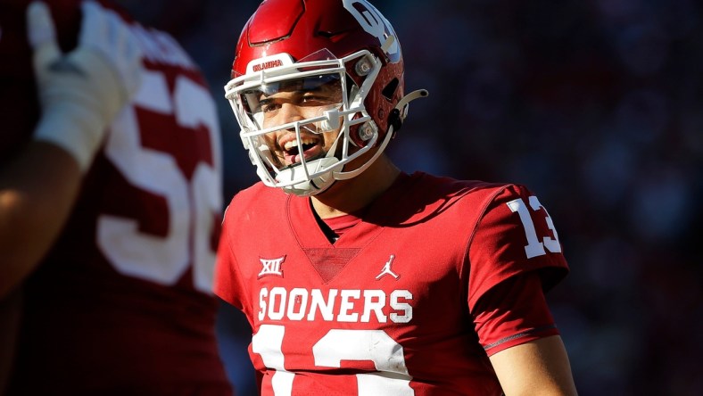 OU quarterback Caleb Williams (13) smiles after throwing a touchdown pass during a 52-21 win against Texas Tech on Saturday at Gaylord Family-Oklahoma Memorial Stadium in Norman.cover main