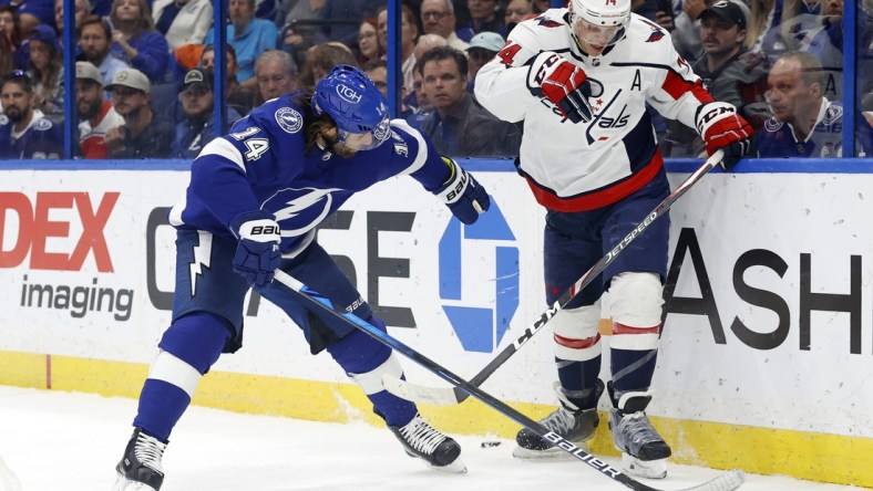 Nov 1, 2021; Tampa, Florida, USA;Tampa Bay Lightning left wing Pat Maroon (14) and Washington Capitals defenseman John Carlson (74) skates with the puck during the first quarter at Amalie Arena. Mandatory Credit: Kim Klement-USA TODAY Sports