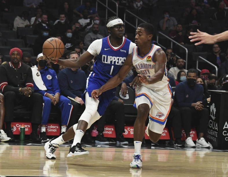 Nov 1, 2021; Los Angeles, California, USA;  LA Clippers guard Reggie Jackson (1) looks to pass the ball defended by Oklahoma City Thunder guard Theo Maledon (11) during the first half at Staples Center. Mandatory Credit: Richard Mackson-USA TODAY Sports