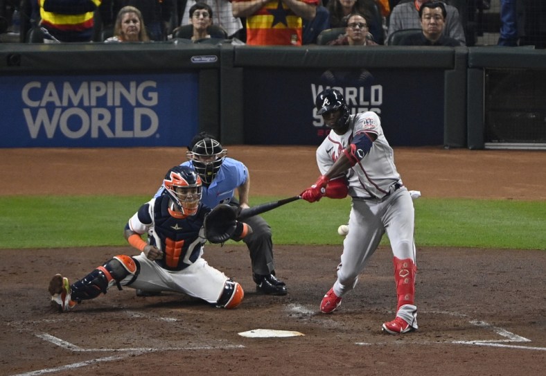 Nov 2, 2021; Houston, Texas, USA; Atlanta Braves designated hitter Jorge Soler (12) hits a three-run home run against the Houston Astros during the third inning of game six of the 2021 World Series at Minute Maid Park. Mandatory Credit: Jerome Miron-USA TODAY Sports