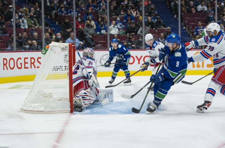 Nov 2, 2021; Vancouver, British Columbia, CAN; Vancouver Canucks forward J.T. Miller (9) scores on New York Rangers goalie Igor Shesterkin (31) in the third period at Rogers Arena. Canucks won 3-2 in overtime. Mandatory Credit: Bob Frid-USA TODAY Sports