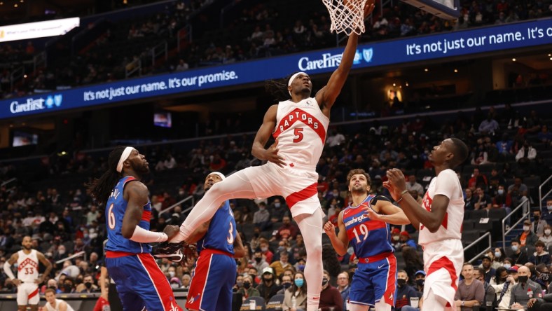 Nov 3, 2021; Washington, District of Columbia, USA; Toronto Raptors forward Precious Achiuwa (5) shoots the ball as Washington Wizards center Montrezl Harrell (6) looks on during the first quarter at Capital One Arena. Mandatory Credit: Geoff Burke-USA TODAY Sports