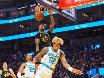 Nov 3, 2021; San Francisco, California, USA; Golden State Warriors guard Gary Payton II (0) dunks the ball above Charlotte Hornets forward-guard Kelly Oubre Jr. (12) during the first quarter at Chase Center. Mandatory Credit: Kelley L Cox-USA TODAY Sports