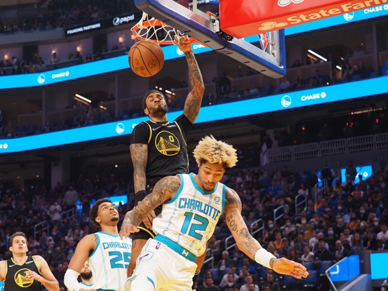Nov 3, 2021; San Francisco, California, USA; Golden State Warriors guard Gary Payton II (0) dunks the ball above Charlotte Hornets forward-guard Kelly Oubre Jr. (12) during the first quarter at Chase Center. Mandatory Credit: Kelley L Cox-USA TODAY Sports