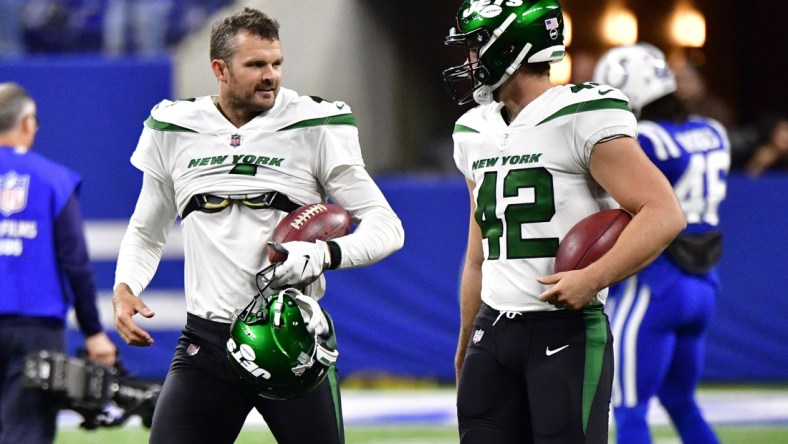 Nov 4, 2021; Indianapolis, Indiana, USA; New York Jets punter Thomas Morstead (left) talks with long snapper Thomas Hennessy (42) before the match against the Indianapolis Colts at Lucas Oil Stadium. Mandatory Credit: Marc Lebryk-USA TODAY Sports